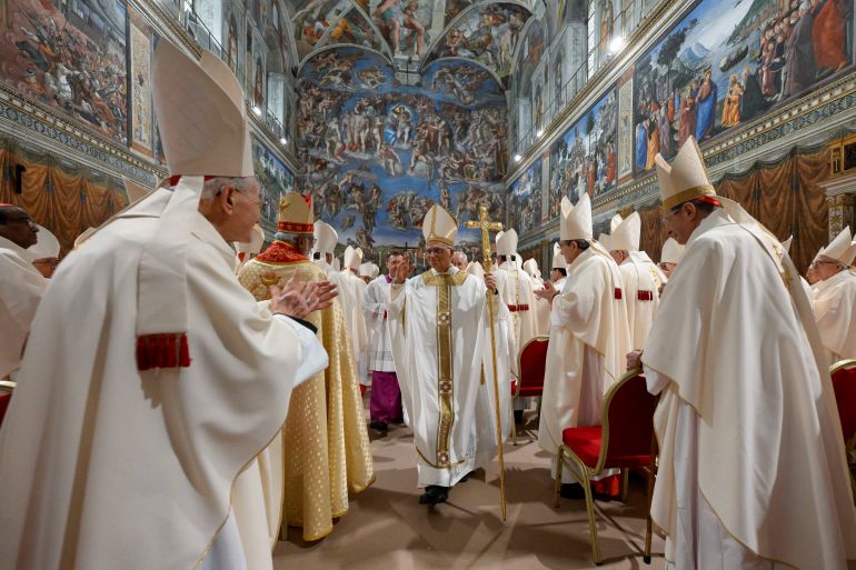 Pope Leo XIV walks in the Sistine Chapel at the Vatican, May 9, 2025. Vatican Media/Francesco Sforza Handout via REUTERS ATTENTION EDITORS - THIS IMAGE WAS PROVIDED BY A THIRD PARTY.
