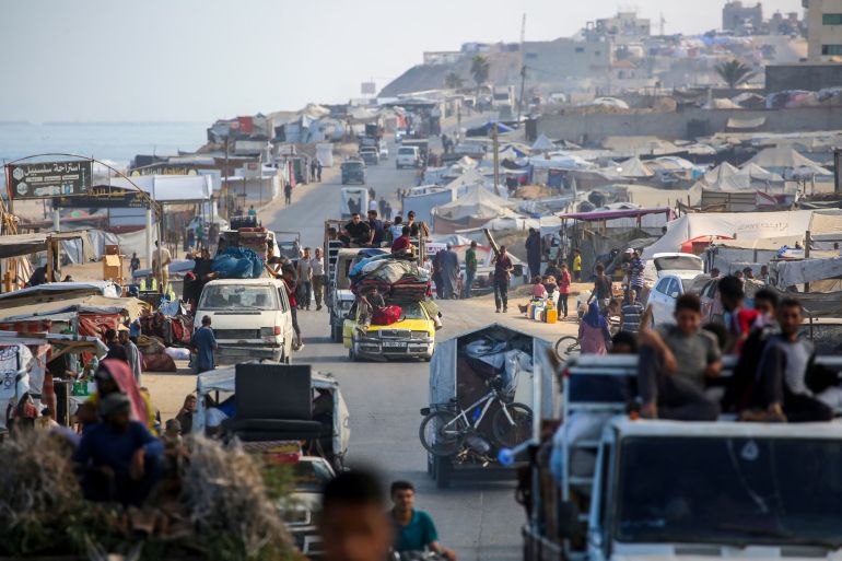 TOPSHOT - Palestinians transport their belongings as they evacuate Gaza City towards southern areas of the coastal Gaza Strip, on September 10, 2025. Israel's military said on September 9, it will act with "great force" in Gaza City and told residents to leave as it stepped up a deadly assault on the Palestinian territory's largest urban centre. (Photo by Eyad BABA / AFP) (Photo by EYAD BABA/AFP via Getty Images)