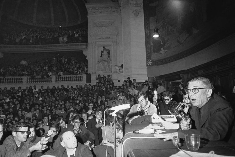 French Philosopher Jean-Paul Sartre, right, addresses Rebellious University students packed into the Sorbonne amphitheater in Paris, France, May 20, 1968. France is nearly paralyzed by a strike spread by a student-worker coalition. (AP Photo)