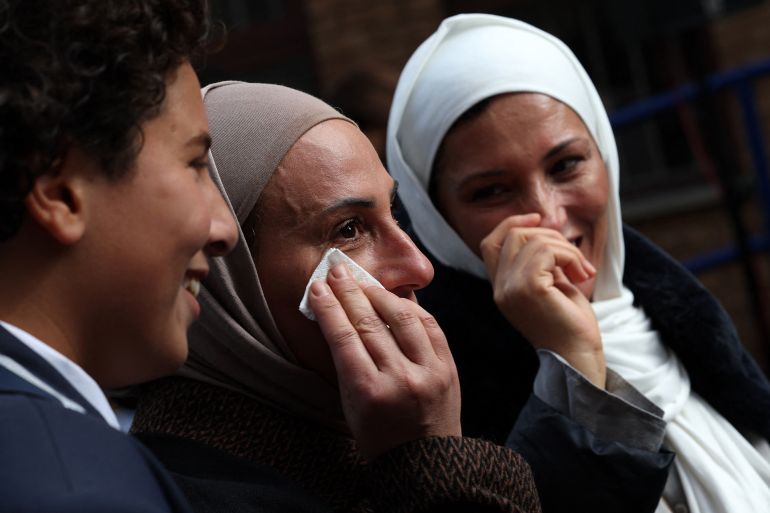 People react during a Palestinian flag-raising ceremony outside the Palestine Mission to the UK, in west London on September 22, 2025.