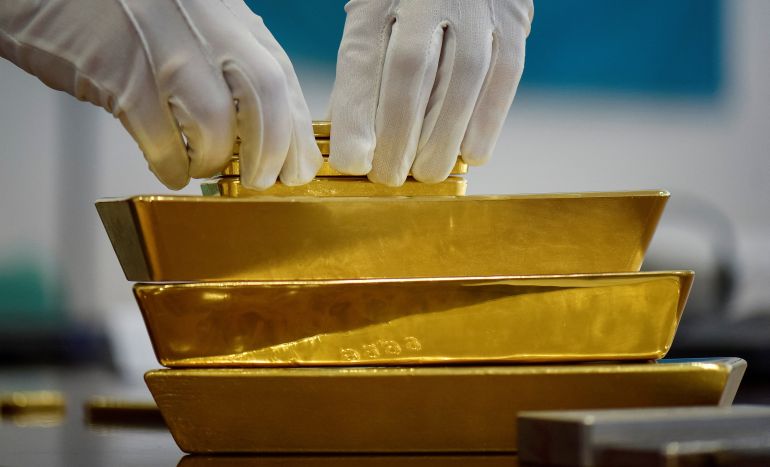 FILE PHOTO: An employee places gold bars in the Kazakhstan's National Bank vault in Almaty, Kazakhstan, September 30, 2016. REUTERS/Mariya Gordeyeva/File Photo