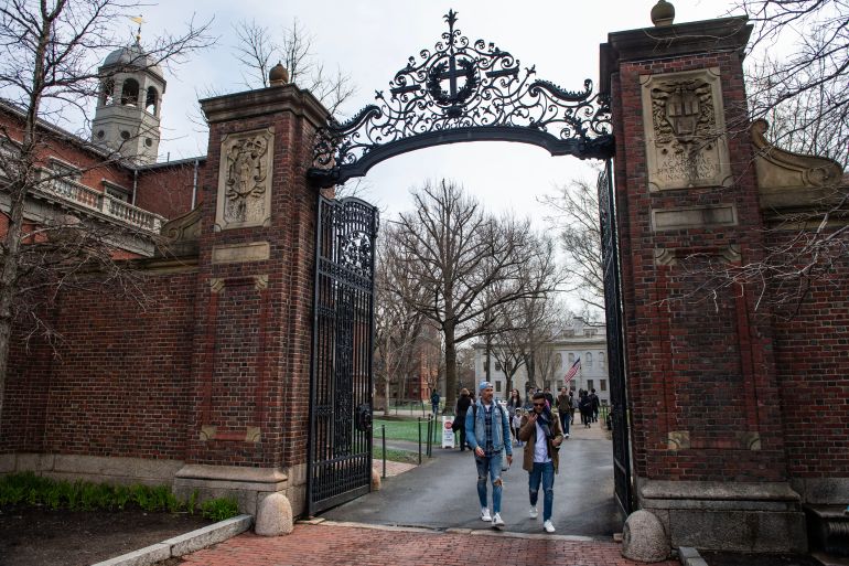 (FILES) People walk through a gate as they exit Harvard Yard on the campus of Harvard University campus in Cambridge, Massachussetts, on April 15, 2025.